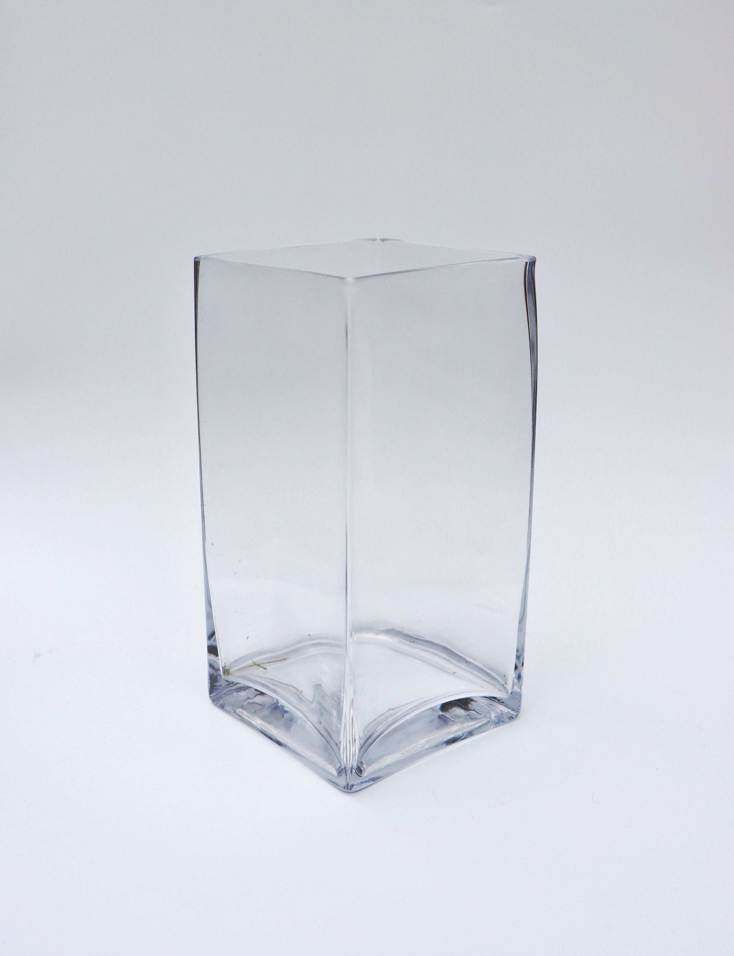 Clear square glass vase on a white background.